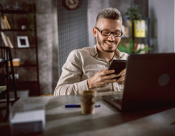 istock Disable male white collar worker in wheelchair using laptop at office 2219035421