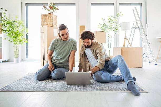 istock Couple Organizing Their Space with a Laptop 2219037528