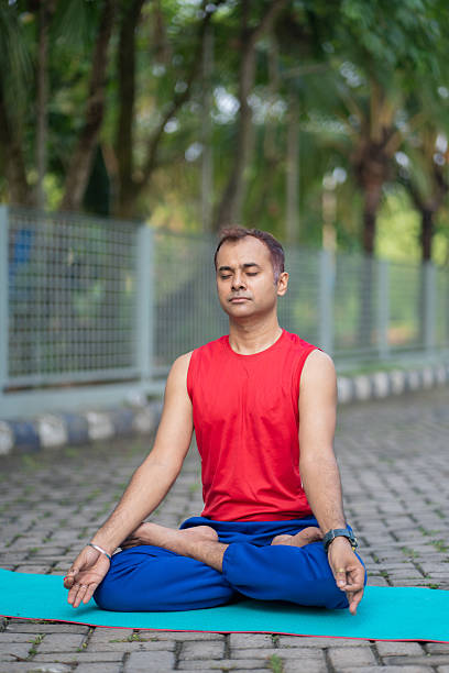 istock Man Meditating in Padmasana (Lotus Pose) Outdoors 2219038886