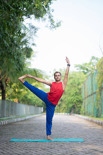 istock Flexible Man in Advanced Standing Yoga Pose 2219038969