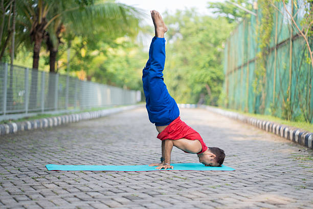 Serene Indian guy practicing yoga outdoors in park