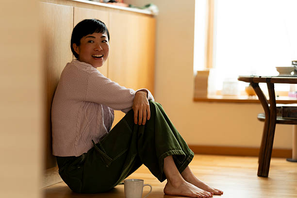 istock Serene woman relaxing on kitchen floor with a mug 2219039961