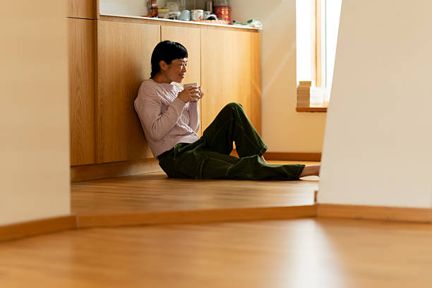 istock Serene woman enjoying a quiet moment with warm drink in modern kitchen 2219039973