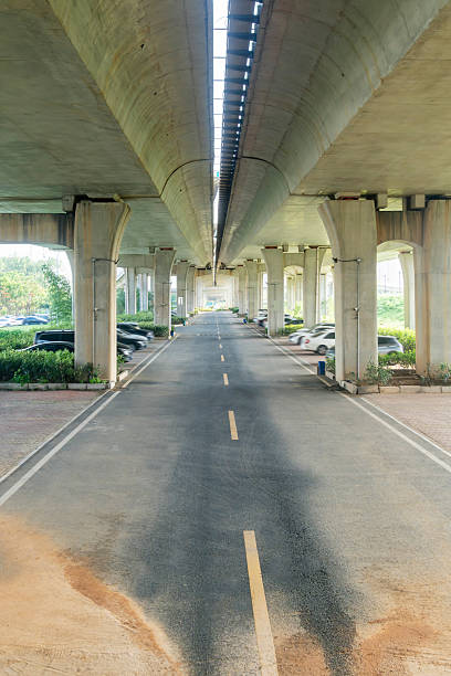 istock Concrete structure and asphalt road space under the overpass in the city 2219040378