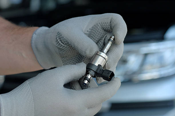 istock Car service. Engine repair. Fuel injector assembly. 2219044108