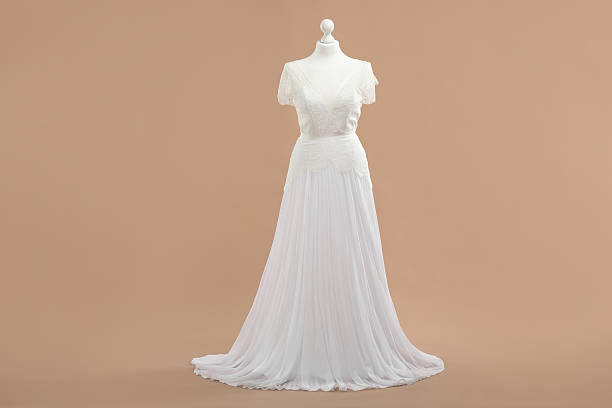istock Mannequin with beautiful wedding dress on pale brown background 2219048192