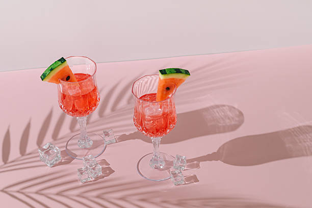 istock Summer scene with refreshing watermelon drink and palm tree leaves shadow on pink and white background. Sun and shadows. Minimal cocktail concept. Trendy summertime party idea. Summer aesthetic. 2219048664