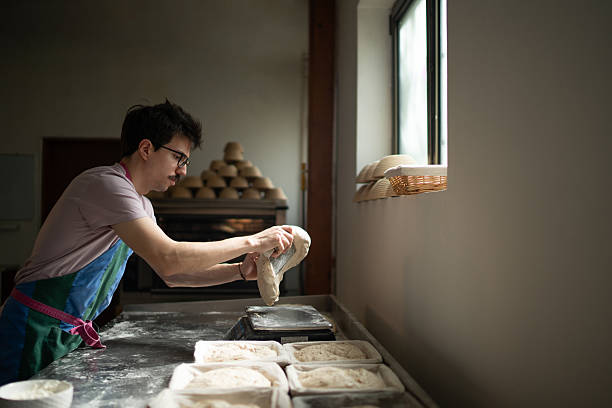 Baker weighing dough for bread making in bakery