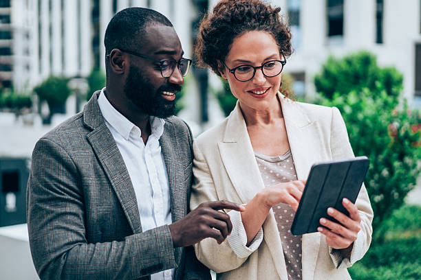 istock Business people using digital tablet outdoors. 2219053160