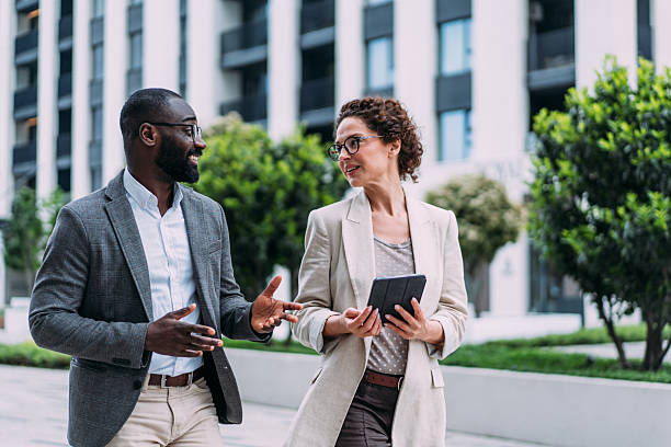 istock Business people using digital tablet outdoors. 2219053161