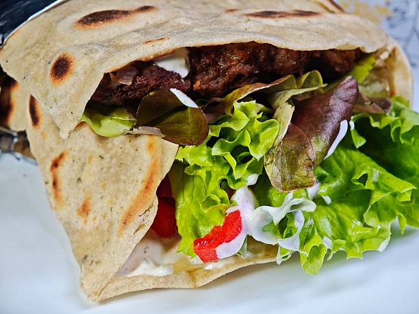 istock Tortilla with vegetables and meat macro kebab 2219054547