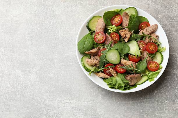 istock Delicious fresh tuna salad on grey table, top view. Space for text 2219054767