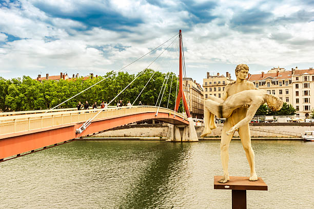 Bridge and the Poids de Soi sculpture at the Soane river in Lyon, France