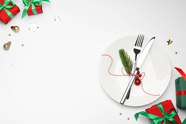 istock Christmas table setting with plate, cutlery and festive decor on white background, flat lay. Space for text 2219055250