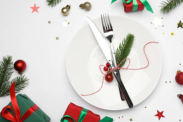 istock Christmas table setting with plate, cutlery and festive decor on white background, flat lay 2219055266