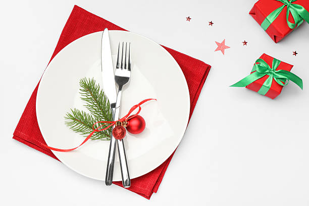 istock Christmas table setting with plate, cutlery, napkin and festive decor on white background, flat lay 2219055269