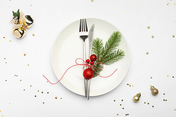 istock Christmas table setting with plate, cutlery and festive decor on white background, flat lay 2219055273