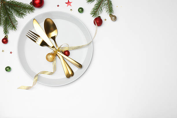 istock Christmas table setting with plate, cutlery and festive decor on white background, flat lay. Space for text 2219055288