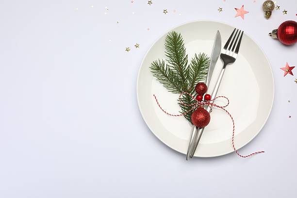 istock Christmas table setting with plate, cutlery and festive decor on white background, flat lay. Space for text 2219055294