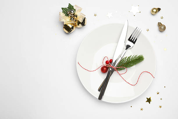 istock Christmas table setting with plate, cutlery and festive decor on white background, flat lay. Space for text 2219055298