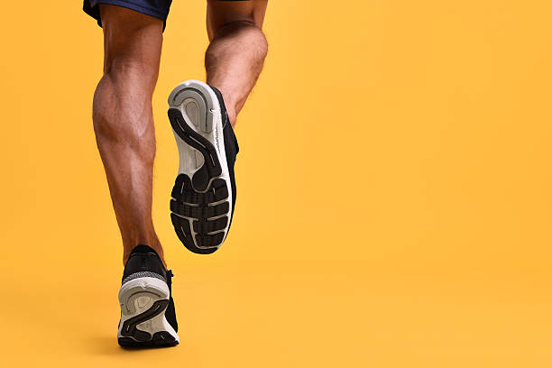 istock Man running on orange background, closeup. Space for text 2219055727