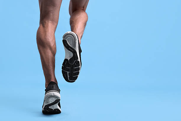 istock Man running on light blue background, closeup 2219055728