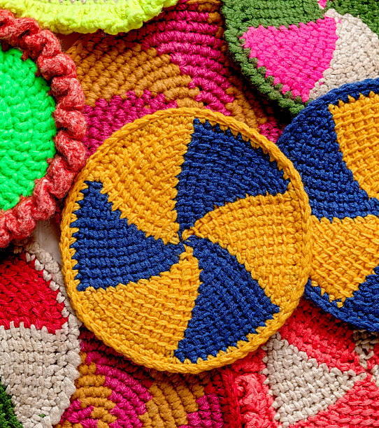 istock Blue yellow crochet cup coaster close up with tunisian pattern. Many round spiral coasters. Knited background. Top view. 2219056041