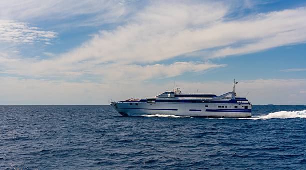 istock Ferry sailing across the ocean under a cloudy sky. 2219058681