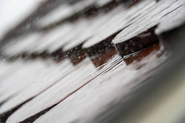 istock Heavy rain patters on roof tiles 2219059712