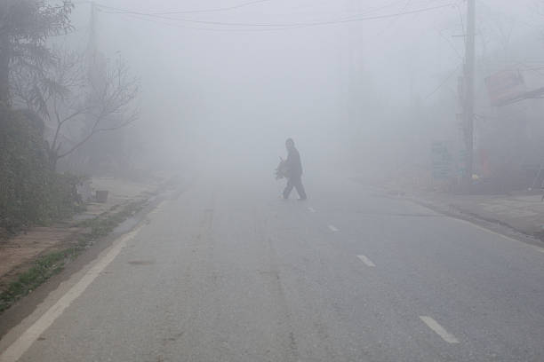 man walking in the fog