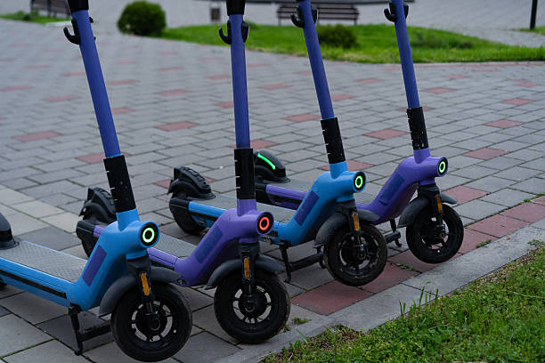 istock Three electric scooters lined up on a city sidewalk during the late afternoon 2219070803