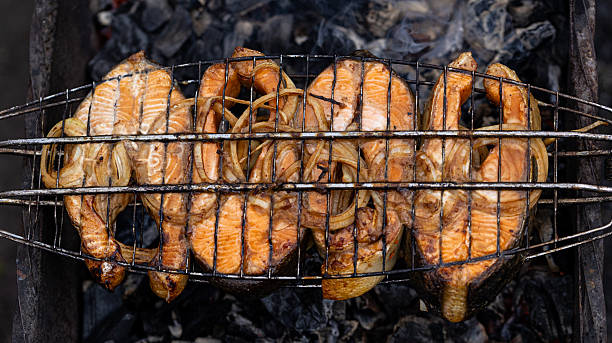 Savor the incredibly delicious grilled salmon steaks accompanied by perfectly cooked onions, a true delight