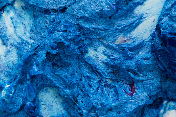 Close-up view of rich blue cream cheese frosting, highlighting its smooth texture and vibrant color, perfect for dessert decoration