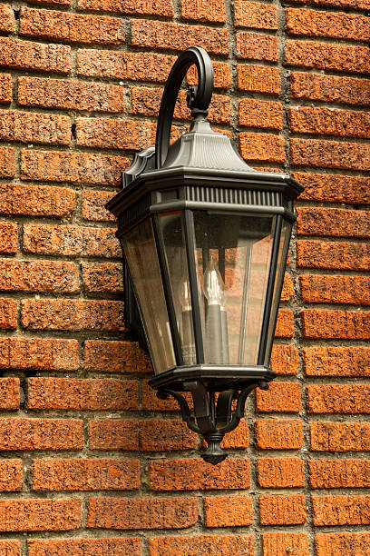 istock A street lamp handing on a brick wall 2219077521