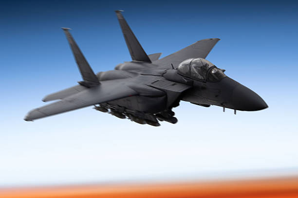 istock Fighter jet in flight over the clouds at sunset 2219078311