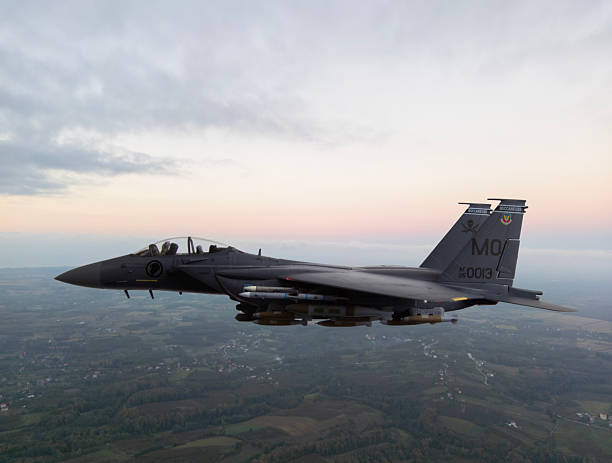 istock F-15 Fighter jet in flight over the country 2219078374
