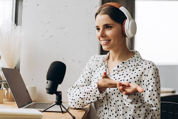 istock Radio host speaking with microphone and headphones recording podcast in studio 2219080608