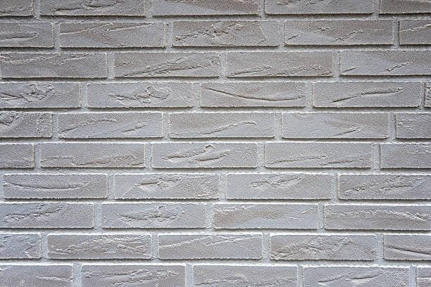 White structural stone wall of the ancient building consists of bricks. Nature structural background.