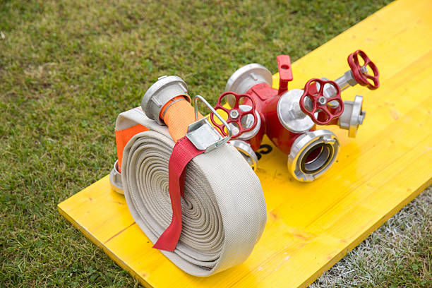 detail of the rolled up hose on the fire truck, textured background fire fighter concept