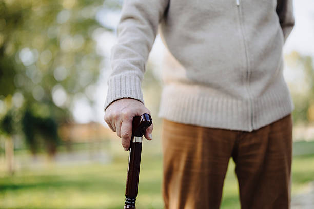 istock Close up of Senior man with walking cane in park. 2219087574