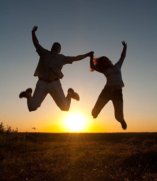Young happy couple relaxing in the summer nature at sunset.