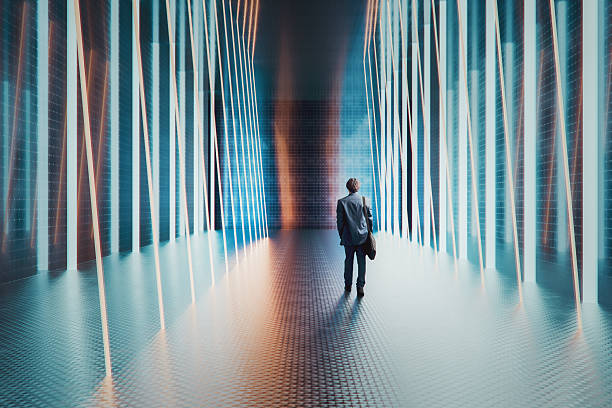 istock Young businessman walking in futuristic corridor 2219096015