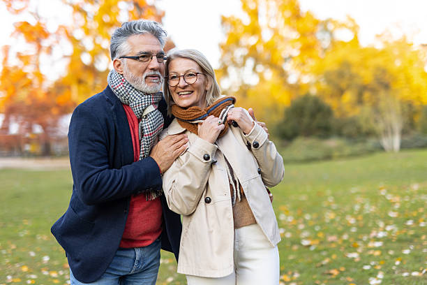 istock Couple warmly embracing in an autumnal park setting 2219100158