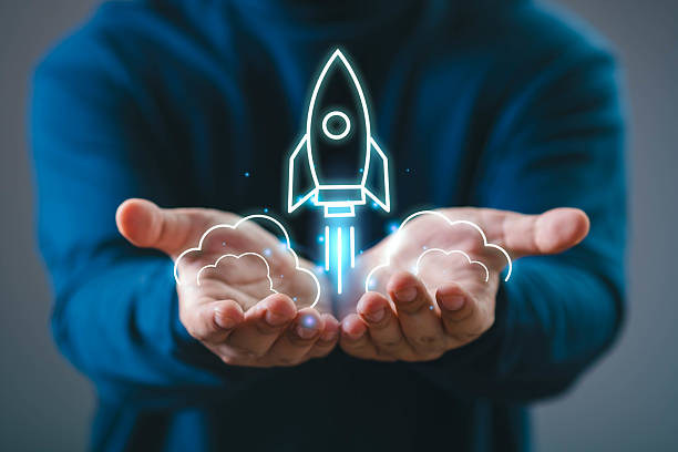 istock Person holding a holographic rocket launching above their hands, symbolizing innovation and startup success. 2219101295