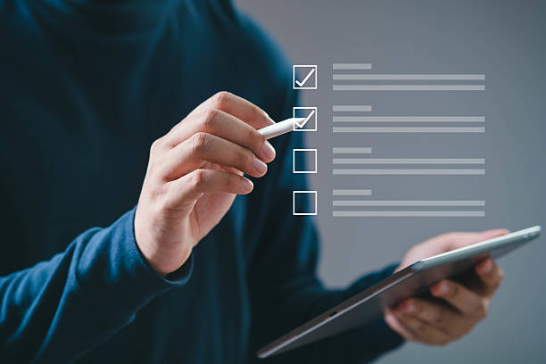 istock Person using a digital tablet to check items on a virtual checklist. Concept of productivity and task management. 2219101298