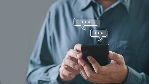 istock A person interacts with a smartphone, sending messages with speech bubbles indicating communication and connection in a modern context. 2219101664