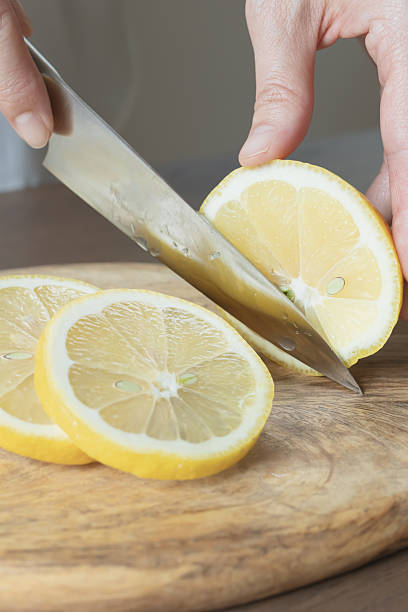 istock Lemon slices. Cut the lemon with a knife. 2219113931