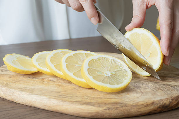 istock Lemon slices. Cut the lemon with a knife. 2219113933