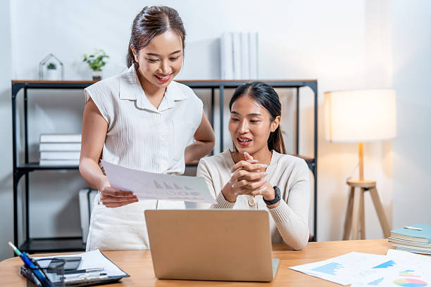 istock Collaborative professionals engage in marketing planning while reviewing cosmetic packaging designs on laptop, showcasing teamwork and creativity in modern workspace 2219119855