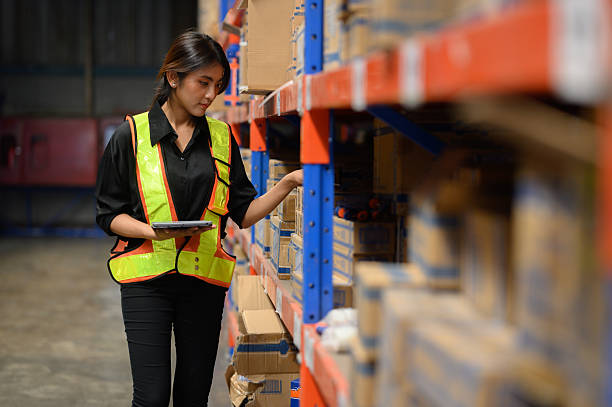 istock Warehouse worker working and checking the stock in the warehouse. .Factory manager using digital tablet check barcode in industry factory logistic. 2219120498